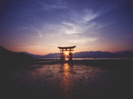 A breathtaking sunset over the famous historic floating torii of Miyajima, Japan